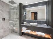 Vanity Area and Glassdoor Shower in Guest Room