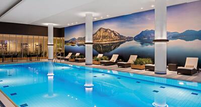 Indoor Pool with Seating Area and Beautiful Wall Decoration