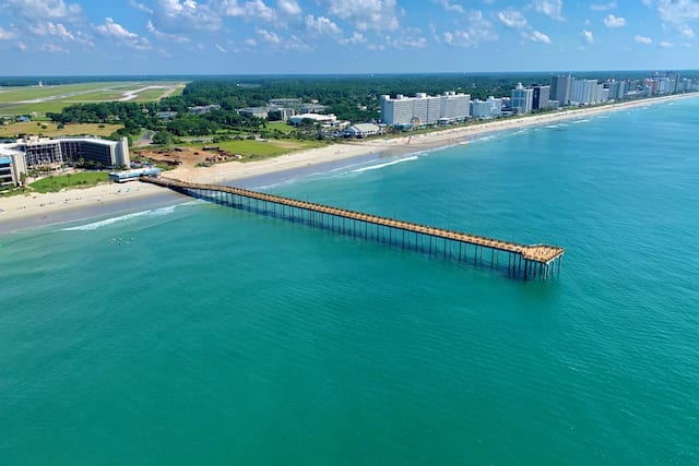 Drone view of boardwalk and exterior of hotel.