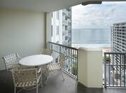 Balcony  with Table and Four Chairs in Hotel Guest Room