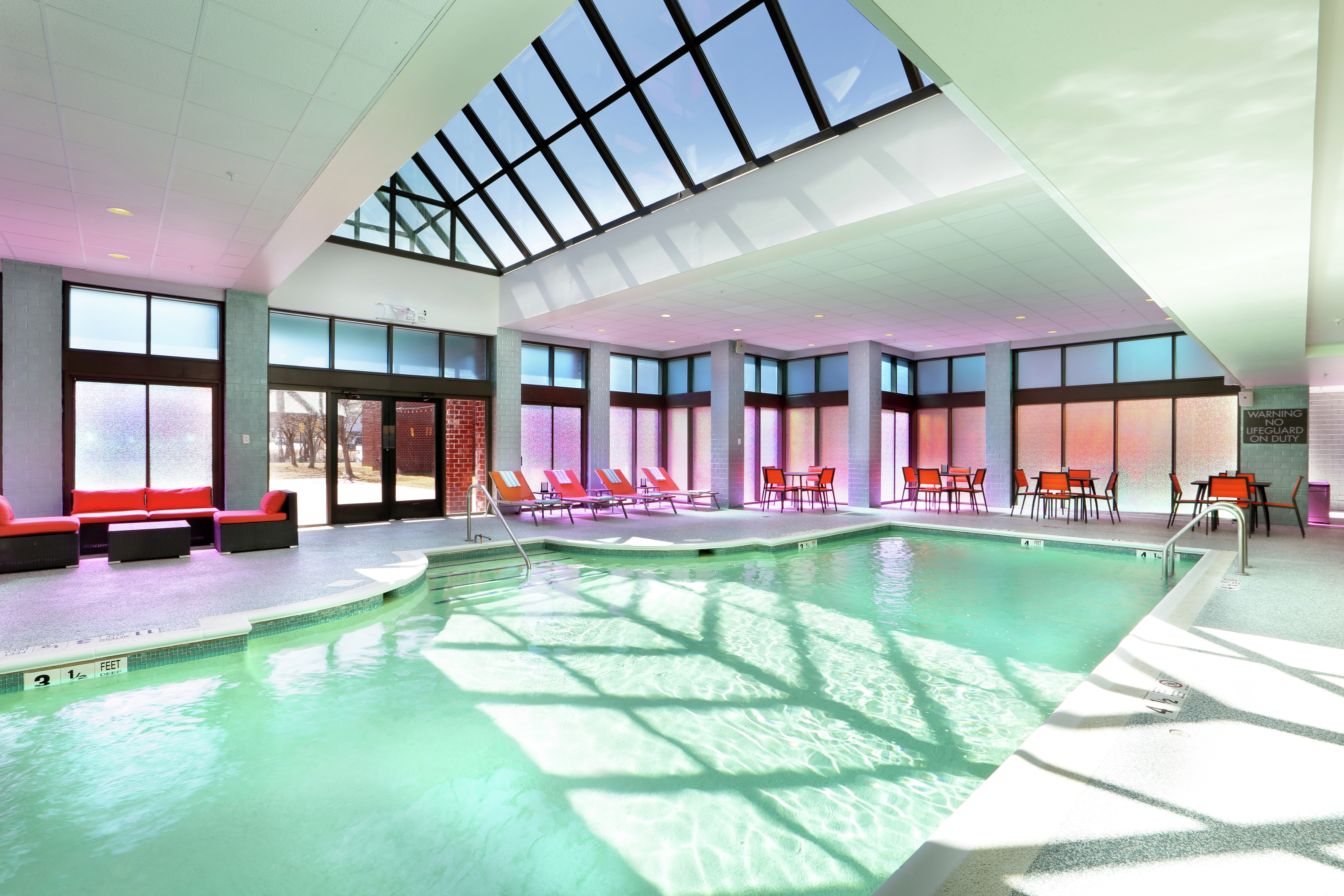 Indoor Pool Area with Seats and Large Windows