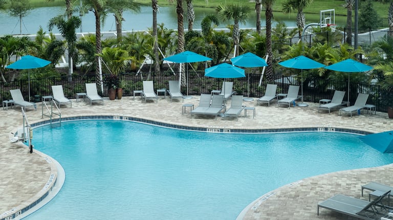 Outdoor Pool with Lounge Chairs under Umbrellas