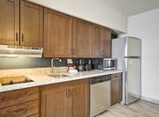 Kitchen with shove, sink, dish washer, coffee maker, microwave and fridge