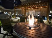 Close-up of outdoor patio firepit, surrounded by chairs