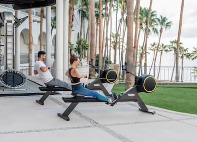 Couple on Outdoor Rowing Machines