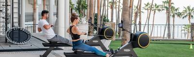 Couple on Outdoor Rowing Machines