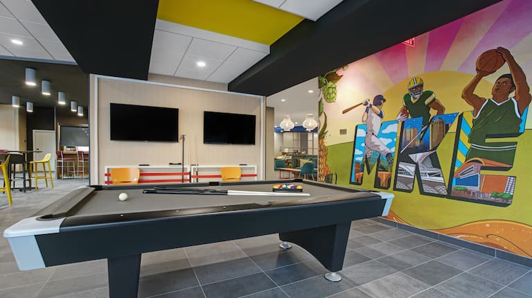 lobby area with pool table and mural