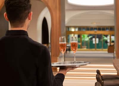 Lobby bar with water holding tray with wine glasses