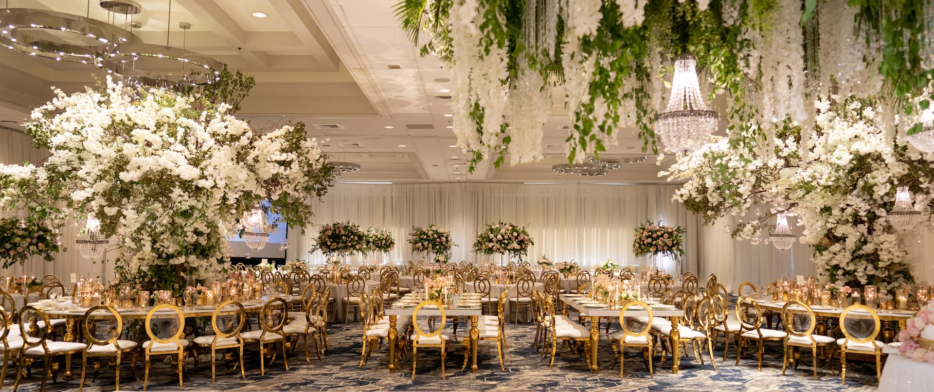 Weddings, ballroom reception tables and hanging flowers