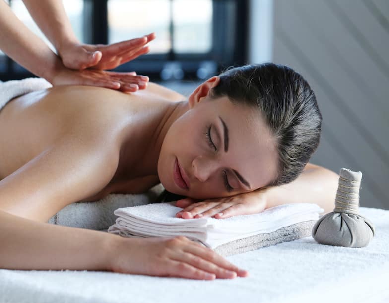 Woman Receiving Massage on Spa Table