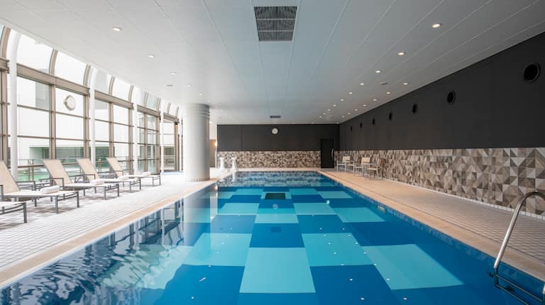 Indoor Pool Area with Seats and Large Windows