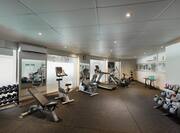 Free Weights, Weight Bench, Large Mirrors, Wall Clock, Cardio Equipment Facing Windows, Weight Balls, and Kettle Bell Weights in Fitness Center