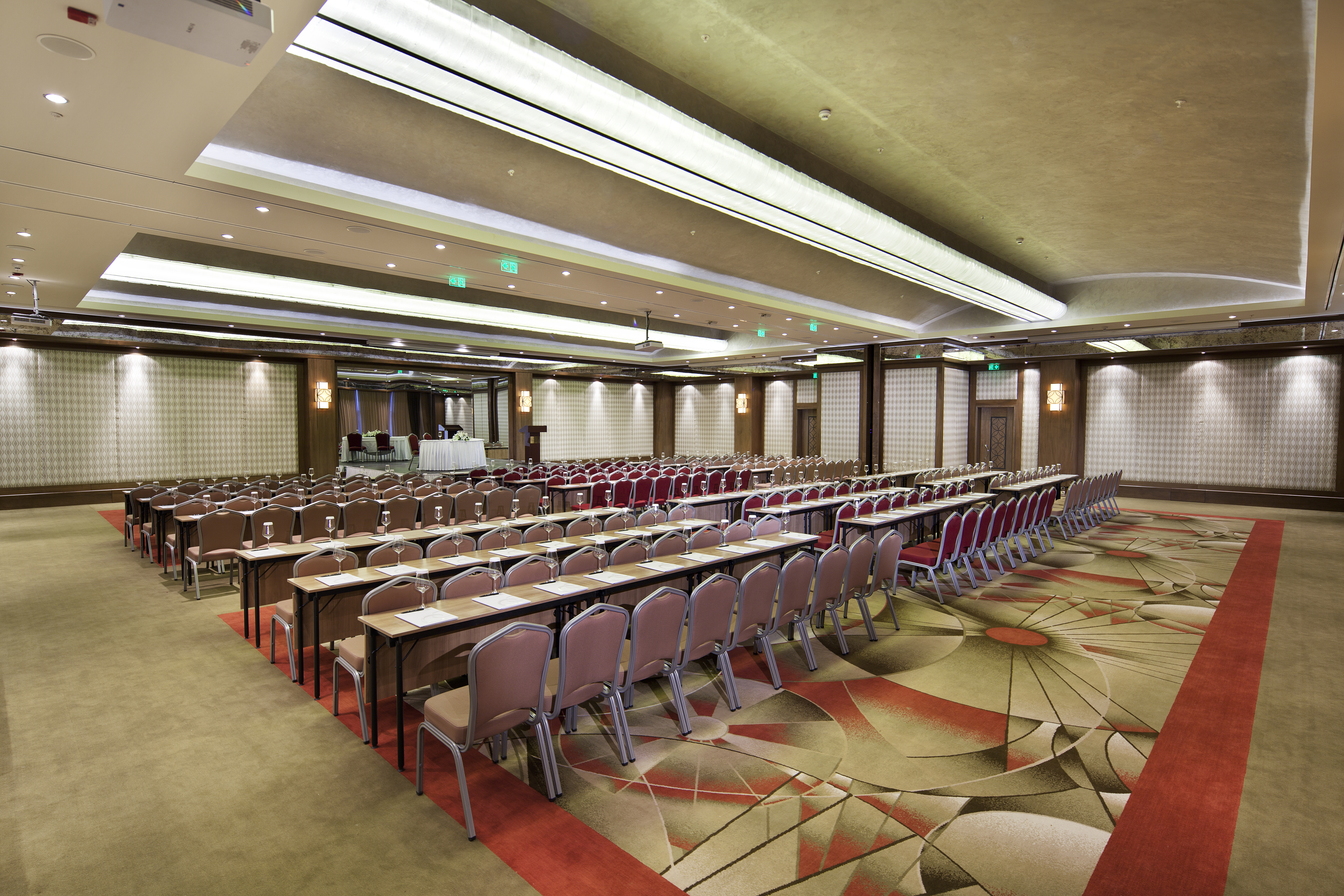 Classroom Setup in Ballroom With Tables and Chairs Facing Presenter's Table and Podium