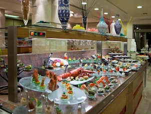 Restaurant Buffet Selections on Counter With View of Dining Tables in Background