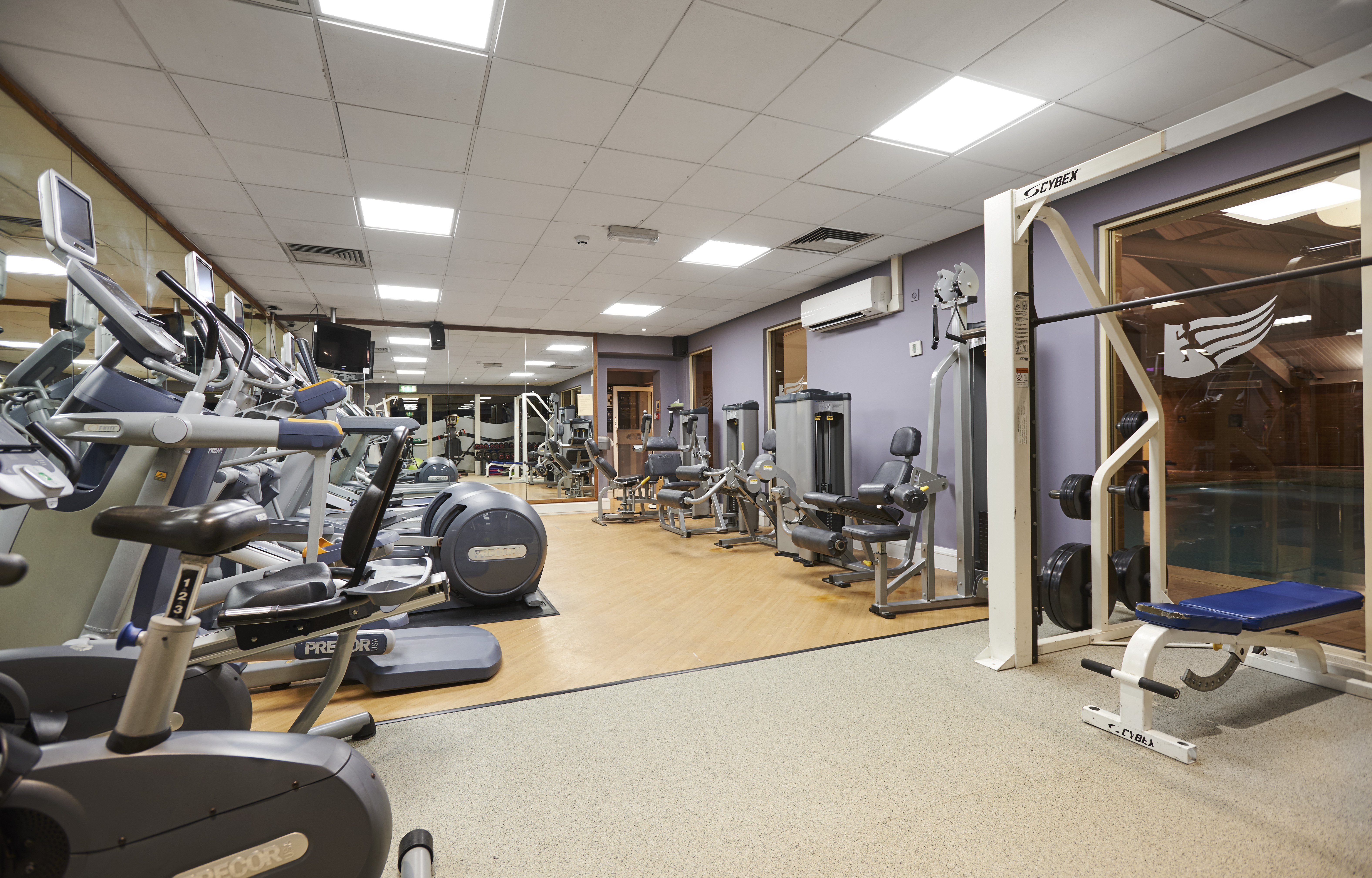 Cardio Equipment, Mirrored Wall, Entry, and Weight Bench in LivingWell Fitness Room