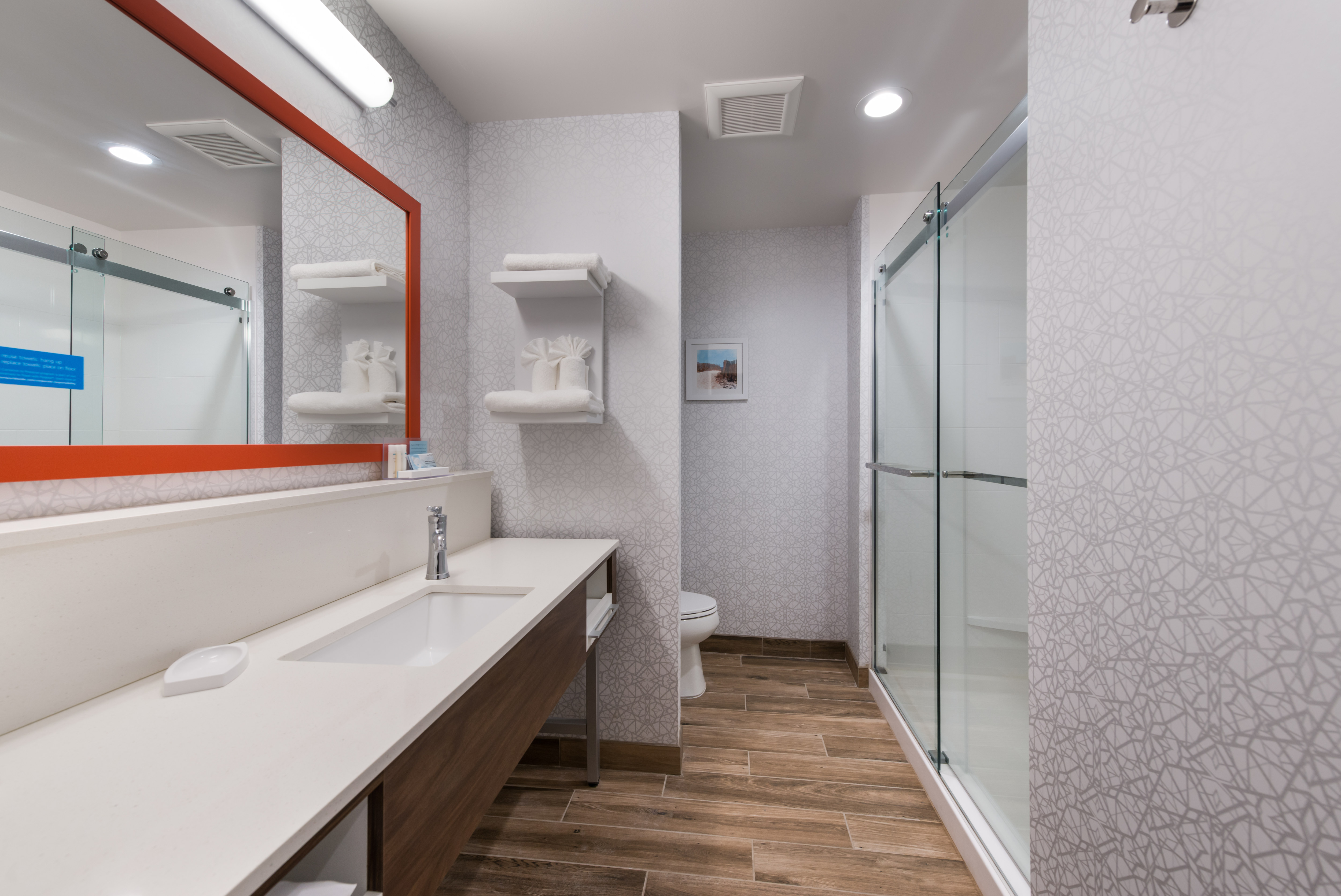Bathroom Vanity Area and Shower with Glass Doors