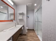 Bathroom Vanity Area and Shower with Glass Doors