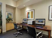 Business Center With Wall Art, Two Computer Workstations, Chairs, and Printer