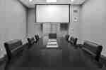 boardroom style meeting space with projection screen