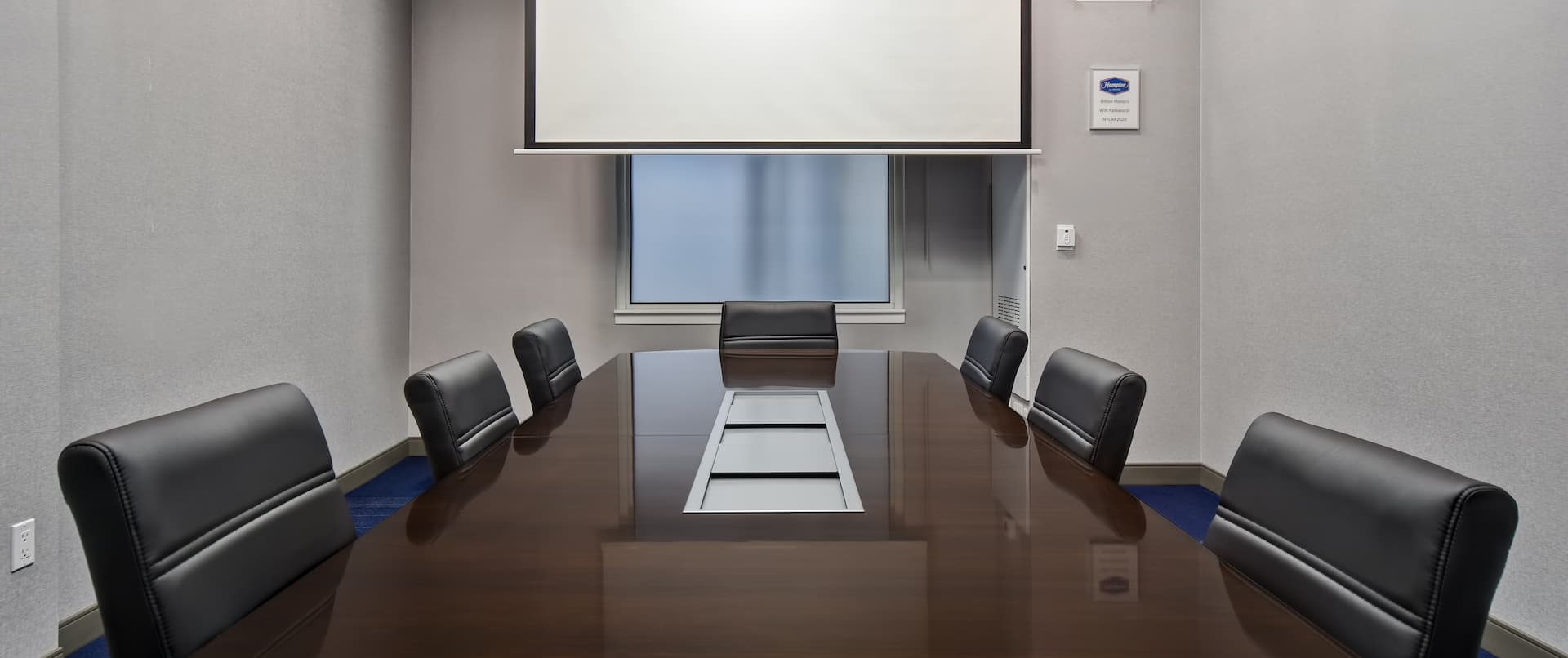 boardroom style meeting space with projection screen