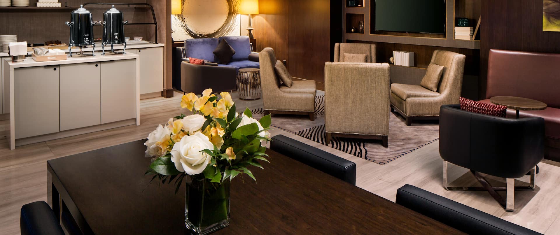 Refreshment Station, Soft Seating, Table with Flowers and Chairs in Executive Lounge