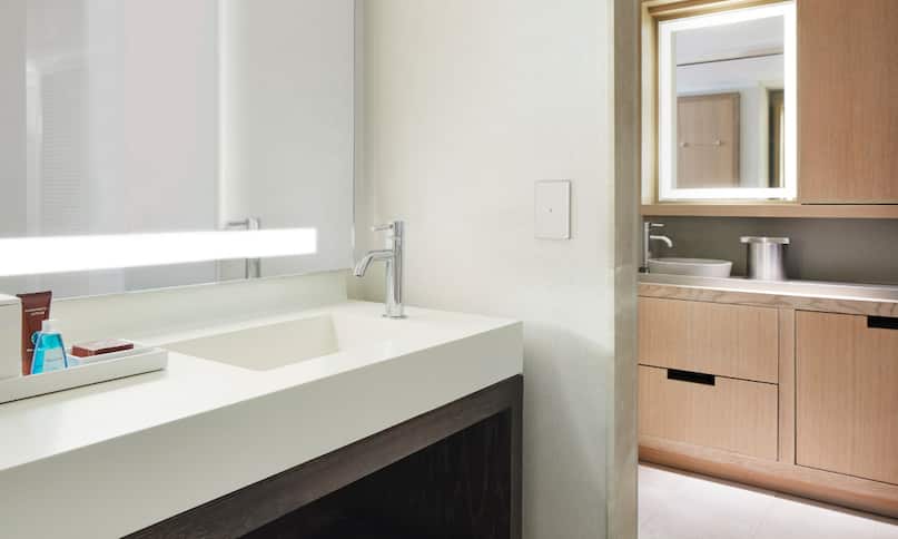 Accessible Deluxe King Suite Bathroom with Mirror, Vanity, and Wet Bar-previous-transition