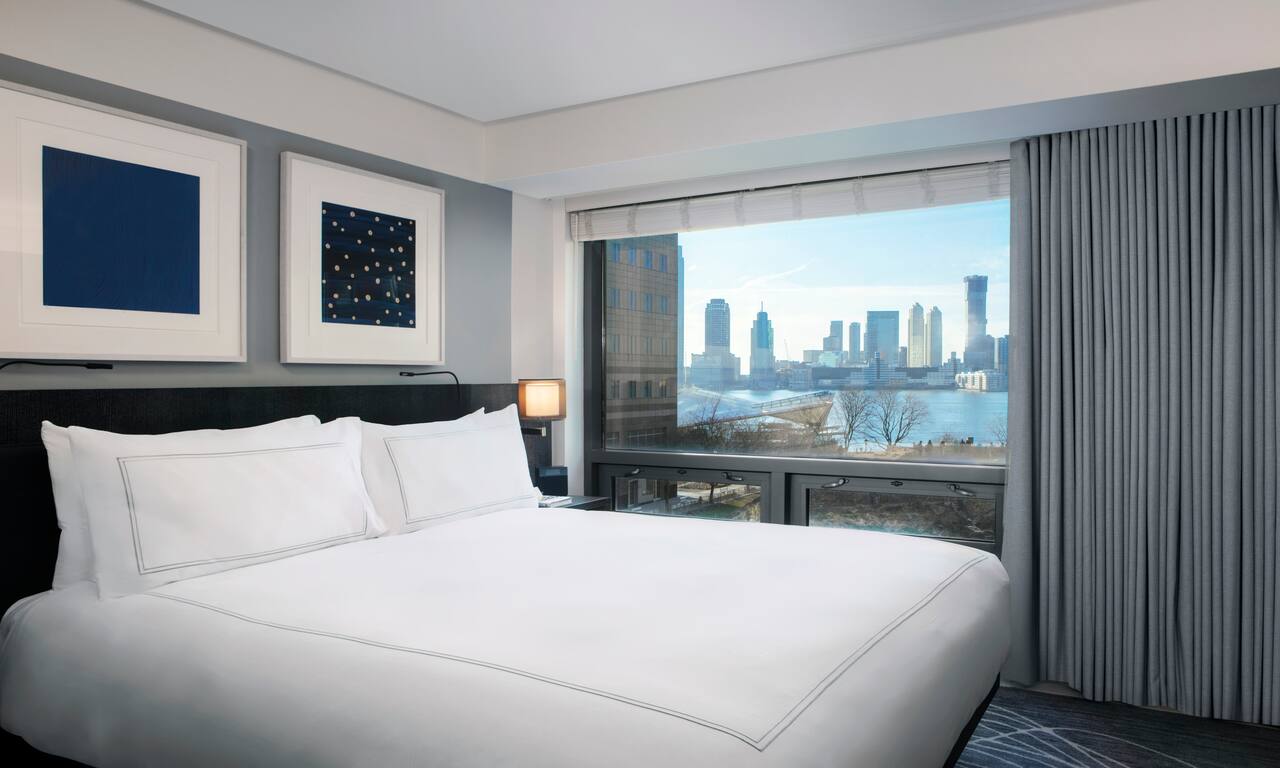 Bed in room with views of skyline-transition