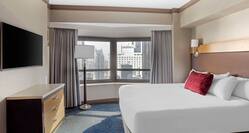Bed and HDTV in Executive Guest Room with City View