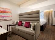 One King Bed Guest Studio with Sofa and Wall Mounted HDTV