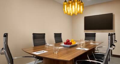 Boardroom with Meeting Table, Office Chairs and Wall Mounted HDTV