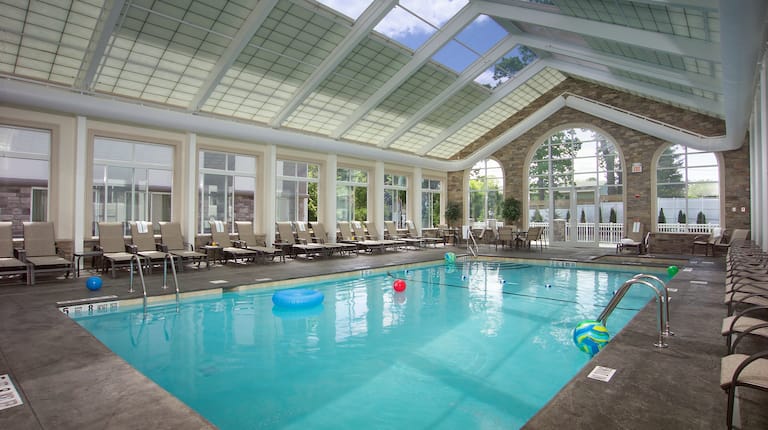 Loungers, Tables and Chairs by Atrium Indoor Pool and Hot Tub