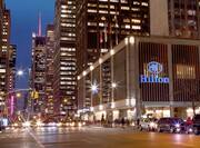 Exterior shot of the New York Hilton Midtown at night.