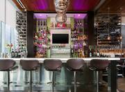 Lobby bar with bar stools and bottles on shelves