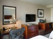 Guestroom with beds, work desk and TV