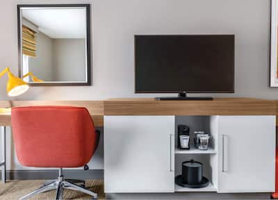 A hotel room workstation with TV and coffee-making facilities