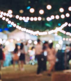 A blurred out shot of an outdoor gathering at night.