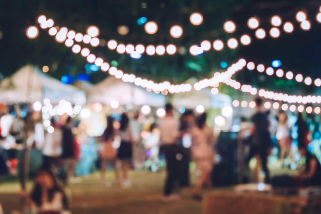 A blurred out shot of an outdoor gathering at night.