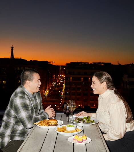 Couple dining outdoors at sunset