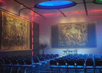 A meeting room set up illuminated with neon lights 