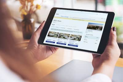 Guest looking at tablet showing Hilton's booking engine
