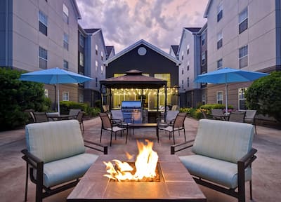 A fire pit surrounded by seats around the patio