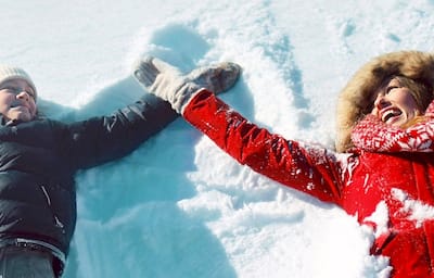 Mother and son making snow angels