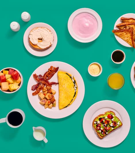 Breakfast dishes set against a blue-green background