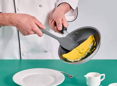 A close up of a chef serving an omelet 