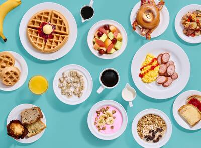 A selection of breakfast plates against a blue-green background