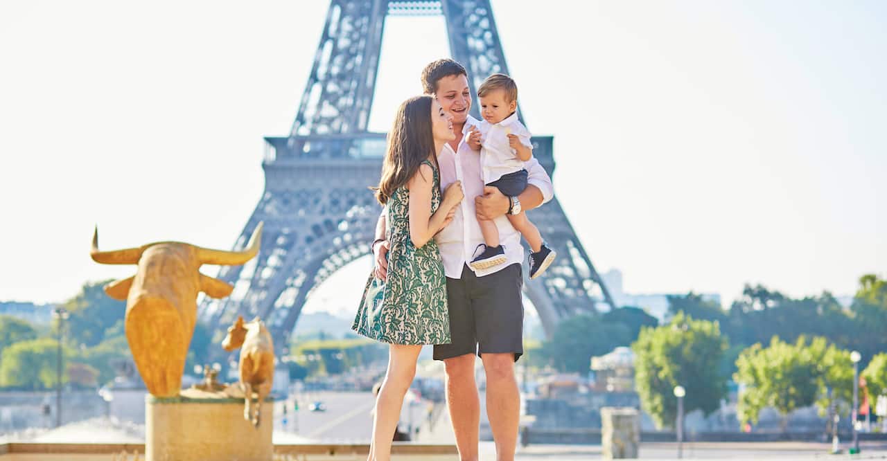 Young family in front of the Eiffel Tower