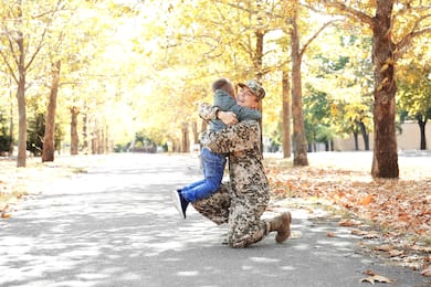 Military mother hugging child