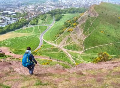 Woman hiking down from Arthur's seat to Edinburgh, Scotland, UK