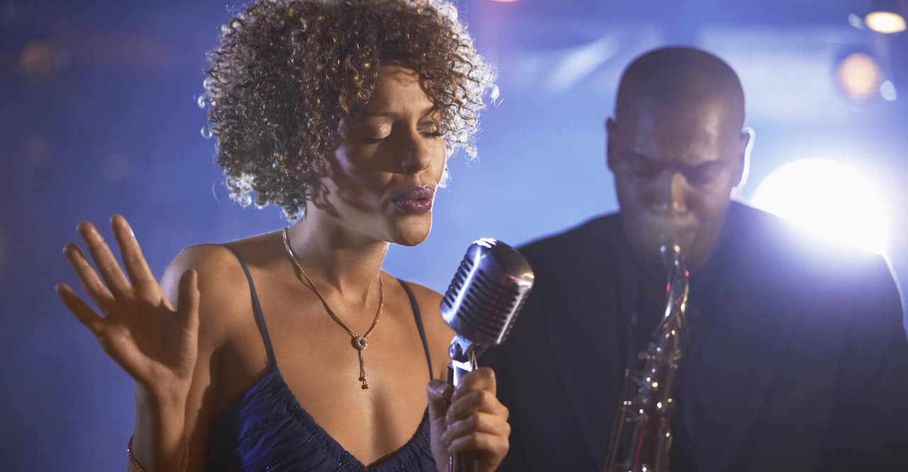 African American singer and saxophonist performing jazz music.