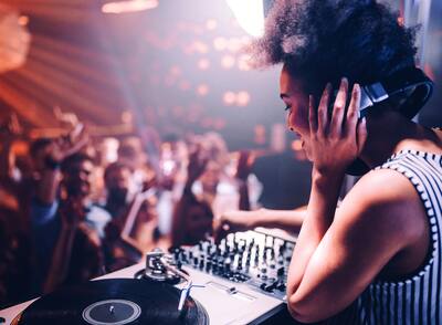female DJ playing music at a dance club